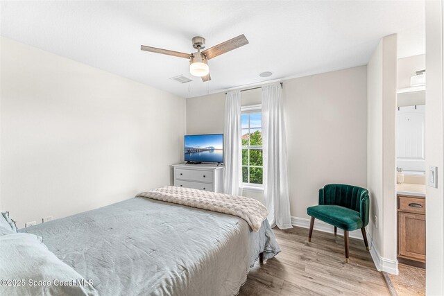 bedroom with wood finished floors, baseboards, a ceiling fan, and visible vents