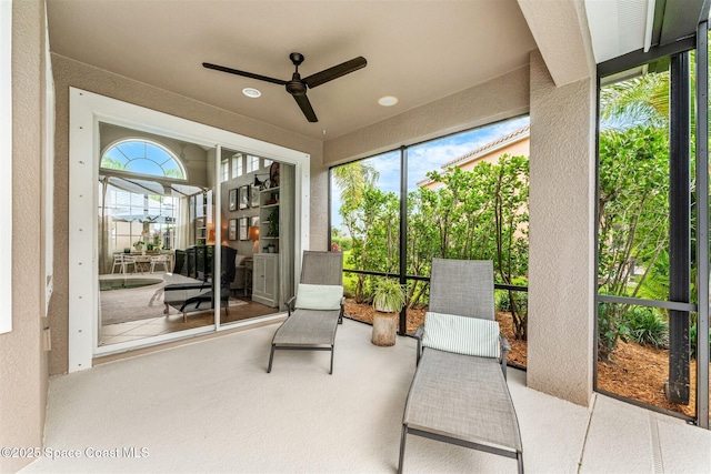 sunroom / solarium featuring ceiling fan and a wealth of natural light