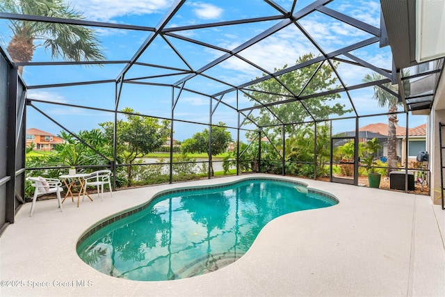 pool featuring a patio area and glass enclosure