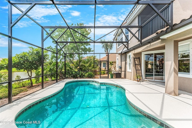 pool with a patio and glass enclosure