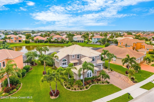 bird's eye view with a residential view and a water view