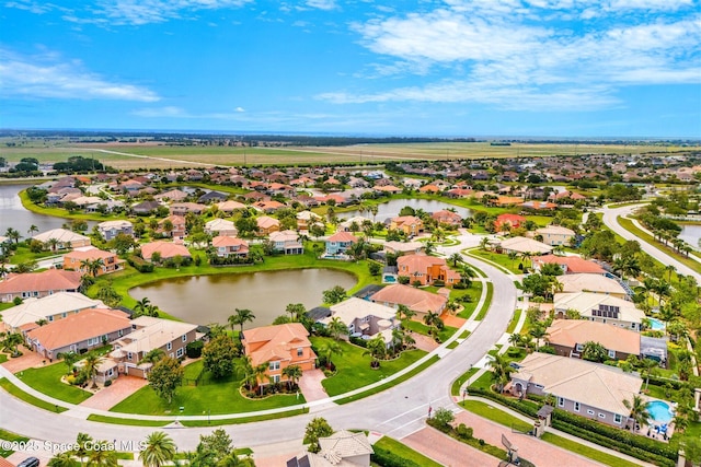 drone / aerial view with a water view and a residential view