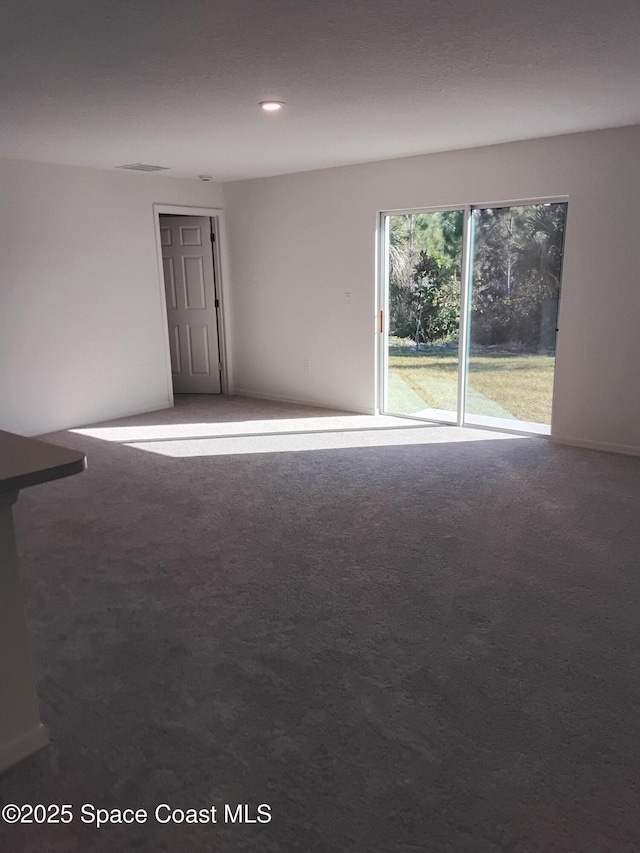 empty room with recessed lighting and carpet floors