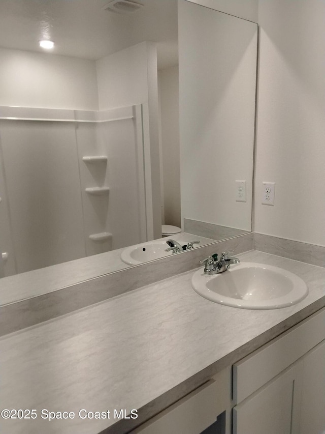 bathroom with vanity and walk in shower