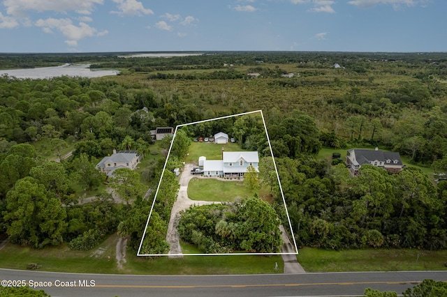 drone / aerial view with a water view and a forest view