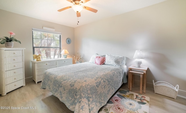 bedroom featuring light wood-type flooring, ceiling fan, and baseboards