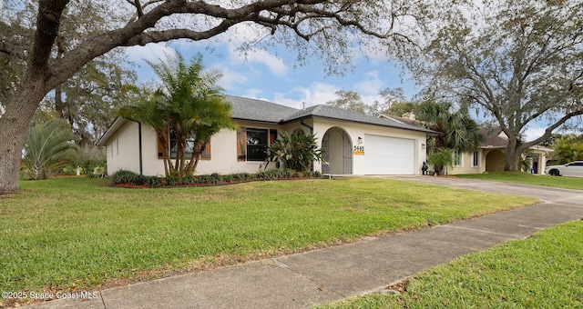 single story home with a front lawn, driveway, an attached garage, and stucco siding