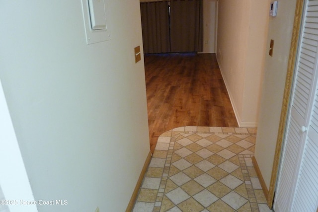 hallway featuring baseboards