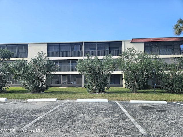 view of property with uncovered parking