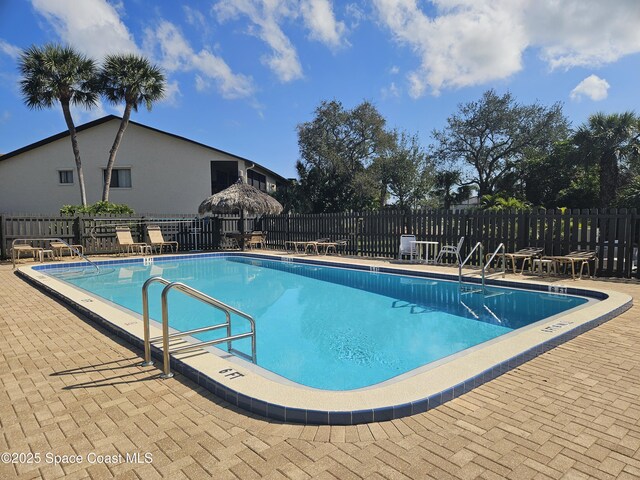 pool featuring a patio and fence