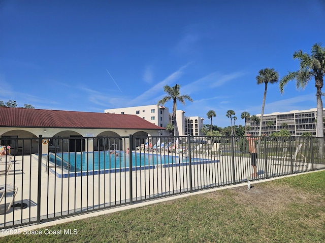 community pool featuring a patio area and fence