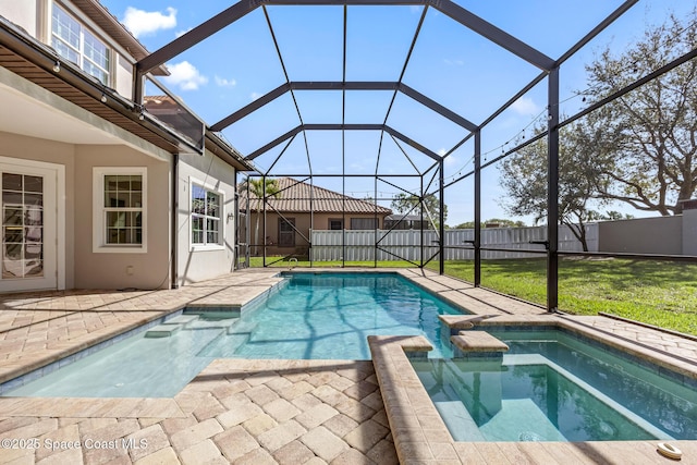 view of swimming pool featuring a lawn, a patio, glass enclosure, a fenced backyard, and a pool with connected hot tub