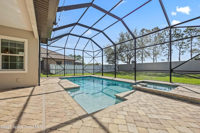 view of pool with a patio area, a lanai, a pool with connected hot tub, and fence