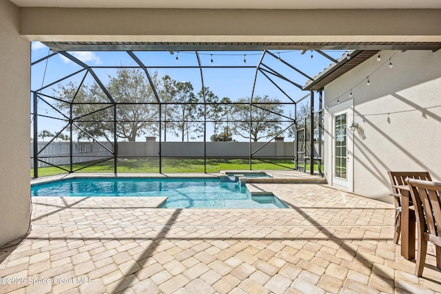 view of swimming pool with a lanai, a pool with connected hot tub, and a patio