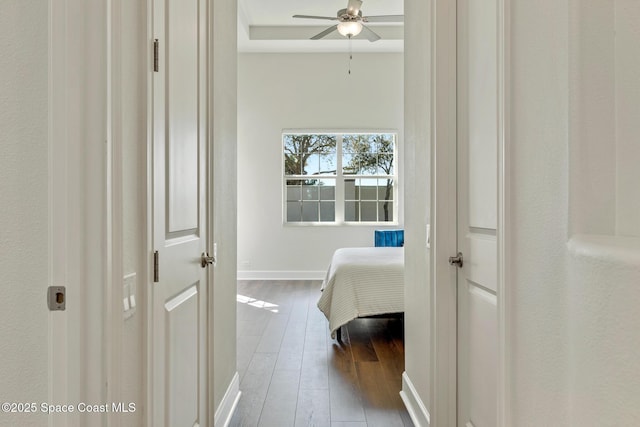 bedroom with baseboards and wood finished floors