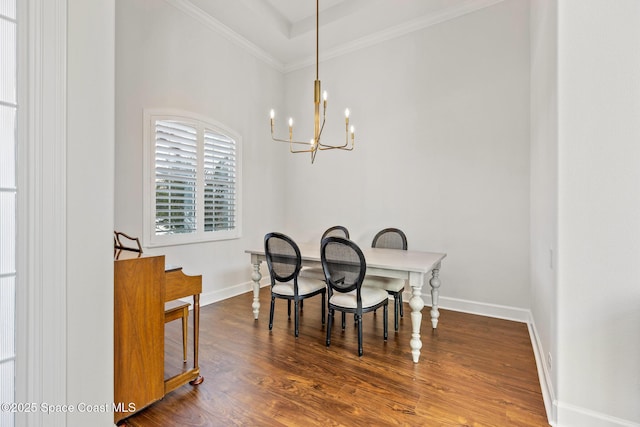 dining area with a chandelier, crown molding, baseboards, and wood finished floors