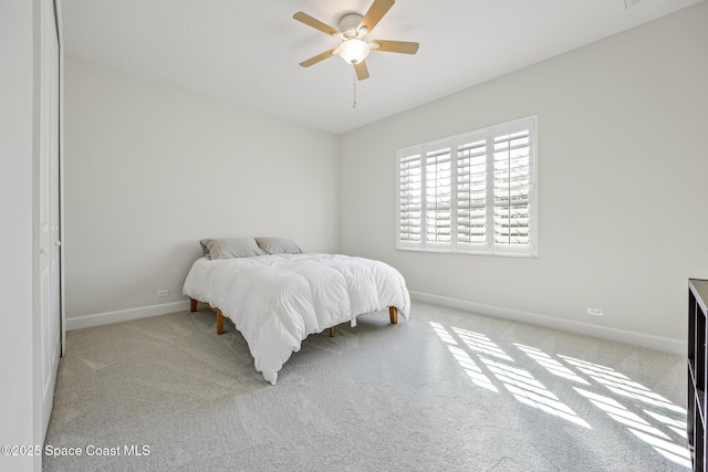 carpeted bedroom featuring ceiling fan and baseboards