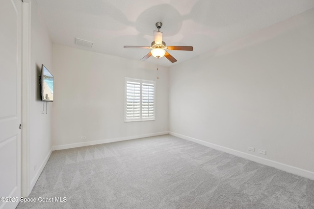 unfurnished room featuring ceiling fan, carpet floors, visible vents, and baseboards