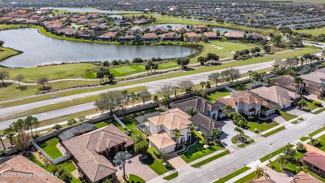 aerial view with view of golf course, a water view, and a residential view