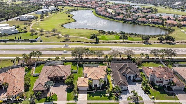 birds eye view of property featuring view of golf course, a water view, and a residential view