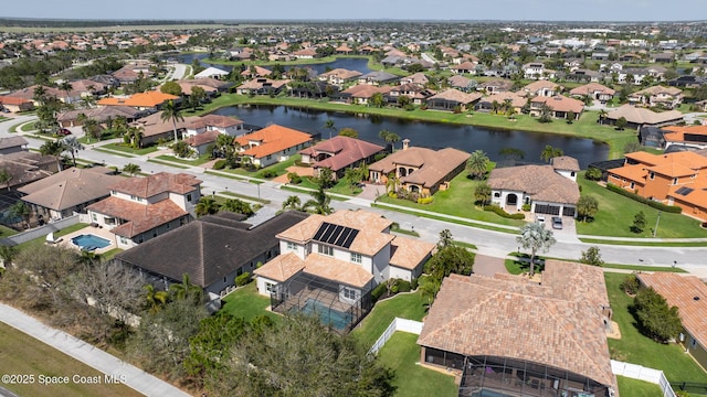 bird's eye view featuring a water view and a residential view