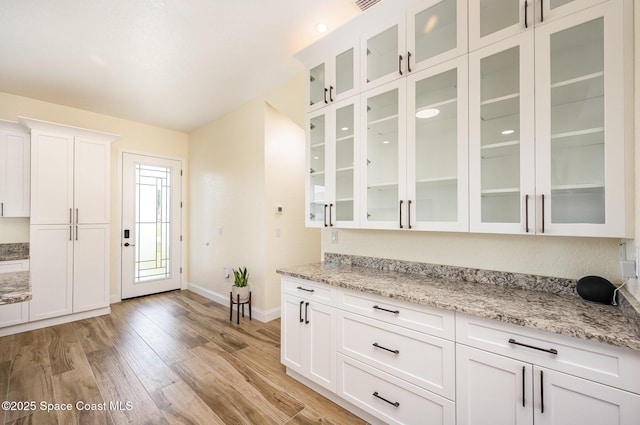 bar with light wood-style floors and baseboards