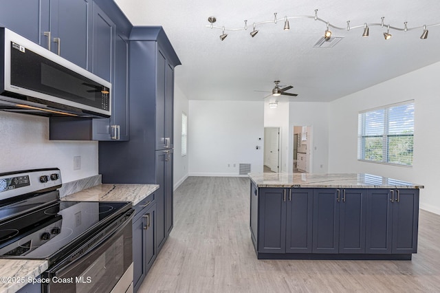 kitchen with visible vents, a ceiling fan, a kitchen island, stainless steel range with electric stovetop, and light wood-type flooring