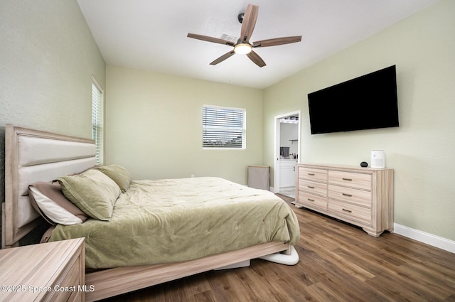 bedroom featuring ceiling fan, baseboards, wood finished floors, and ensuite bathroom