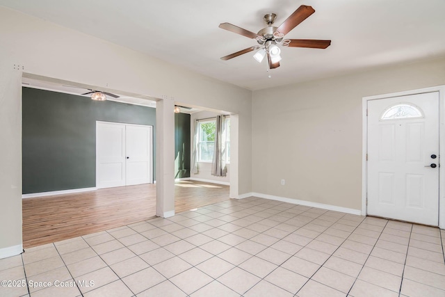 entrance foyer with light tile patterned floors, baseboards, and a ceiling fan