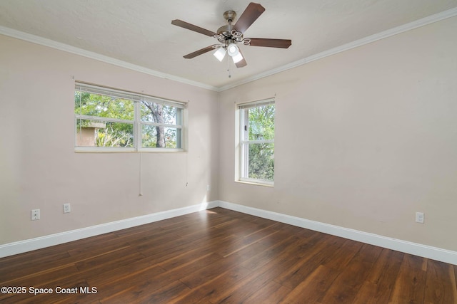 empty room with ceiling fan, baseboards, dark wood finished floors, and ornamental molding