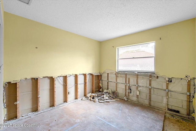 spare room with a textured ceiling