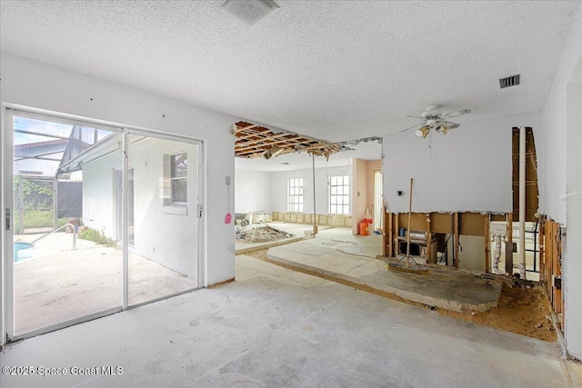 spare room with visible vents, a textured ceiling, and unfinished concrete floors