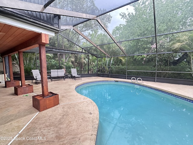 pool with a lanai and a patio area