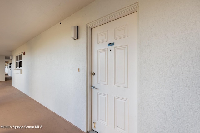 doorway to property featuring stucco siding