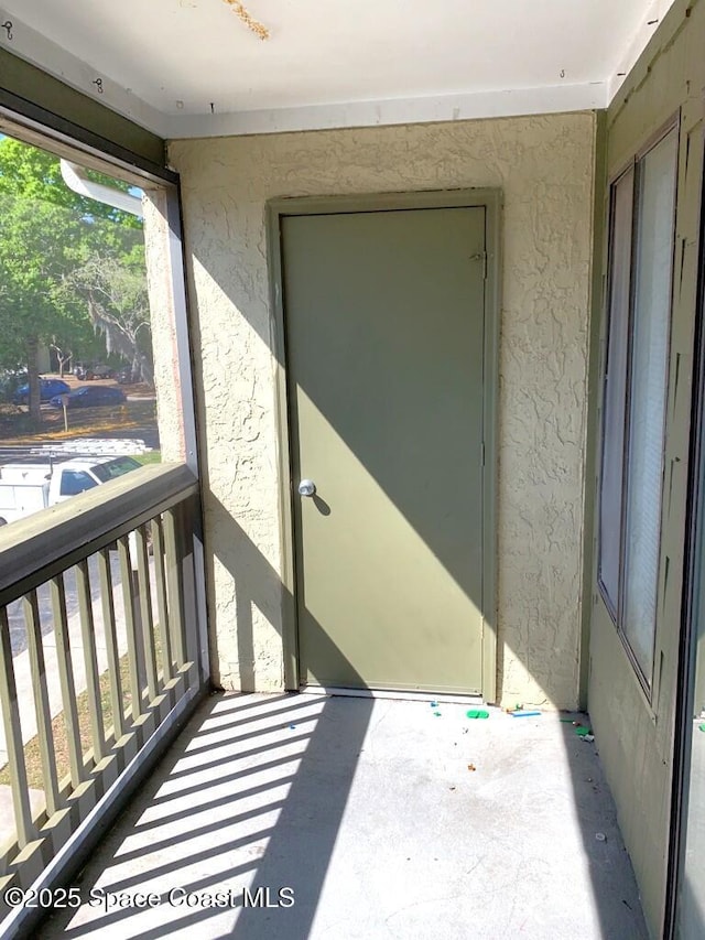 exterior space featuring a balcony and stucco siding