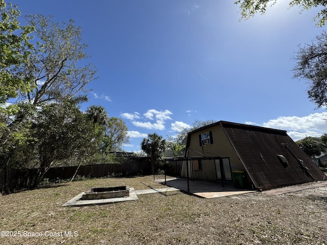 view of yard with a patio area, a fenced backyard, and a fire pit