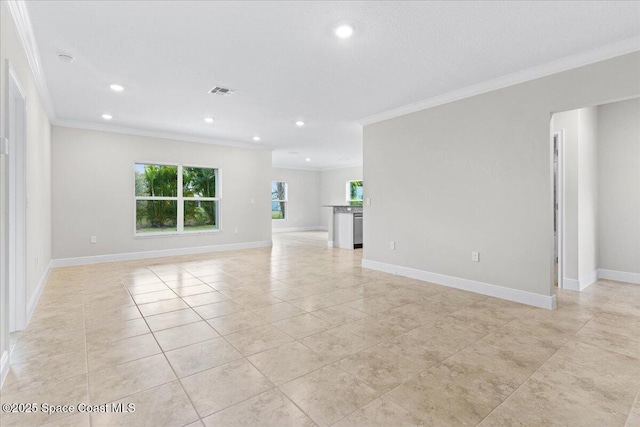 unfurnished living room featuring ornamental molding and baseboards