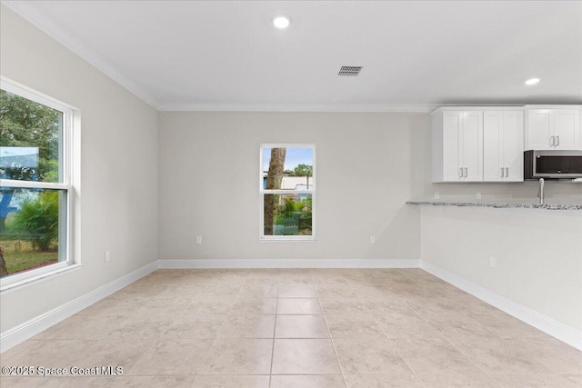 interior space with light tile patterned floors, recessed lighting, visible vents, baseboards, and crown molding