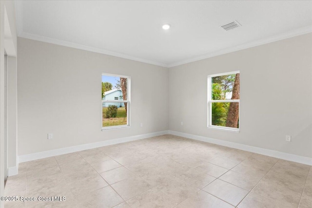 spare room featuring visible vents, crown molding, baseboards, and light tile patterned flooring