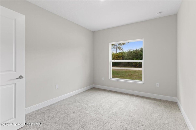 empty room with carpet flooring and baseboards