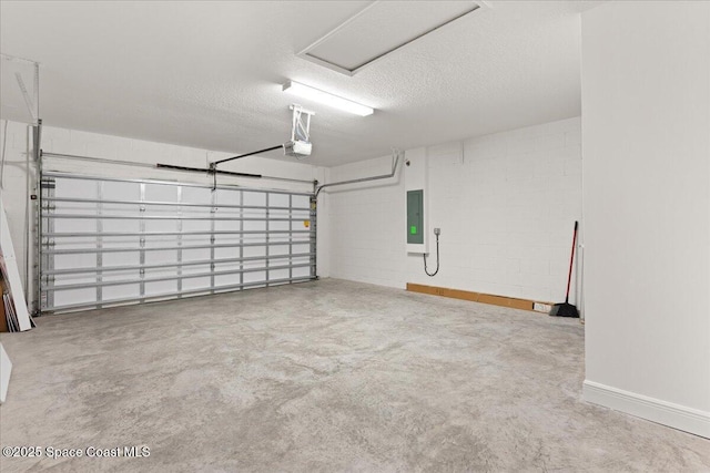 garage with concrete block wall, electric panel, and a garage door opener