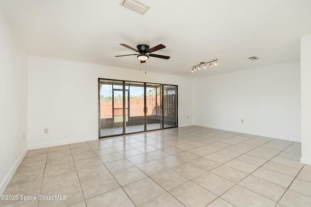 unfurnished room featuring baseboards, visible vents, and ceiling fan