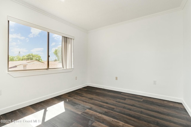 empty room with dark wood finished floors, baseboards, and ornamental molding