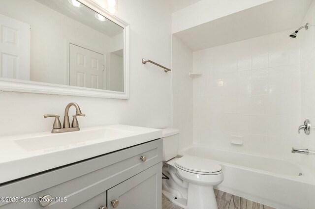 bathroom with vanity,  shower combination, and toilet