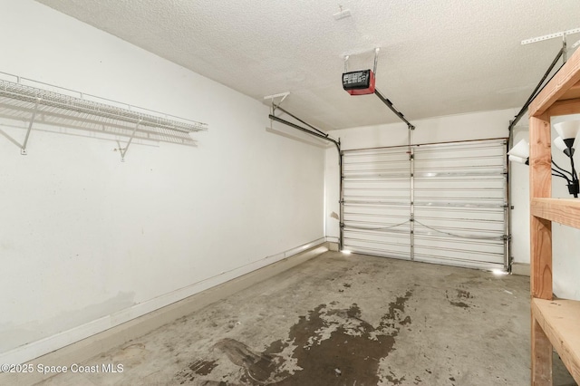 garage with baseboards and a garage door opener
