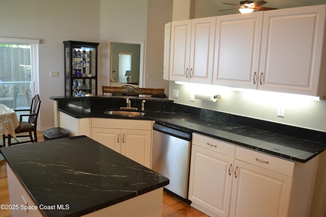 kitchen with a sink, dishwasher, and white cabinets