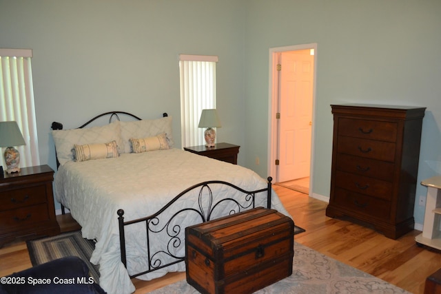 bedroom featuring baseboards and wood finished floors