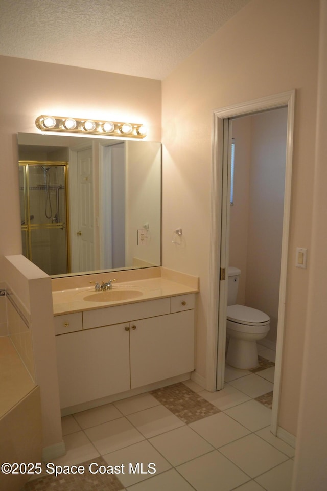 full bathroom with vanity, tile patterned flooring, a shower stall, a textured ceiling, and toilet