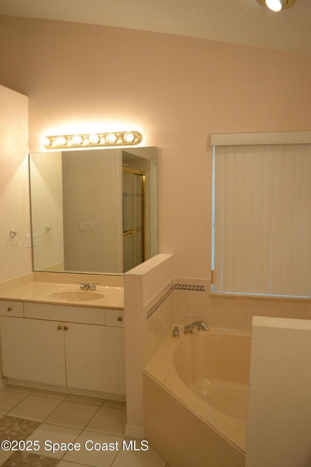 bathroom with tile patterned flooring, a garden tub, vanity, and a shower with door