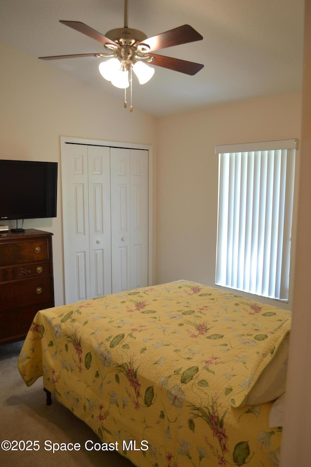 bedroom with a closet, ceiling fan, and lofted ceiling